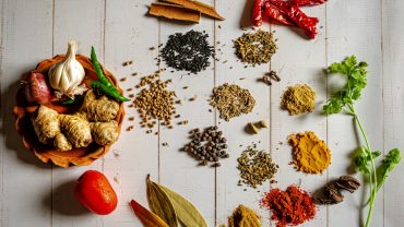 Guide showing fresh spices on a Zanzibar spice farm tour
